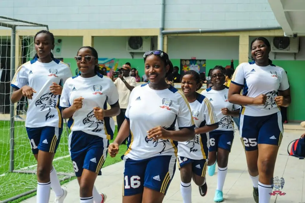American School of Douala girls' football team warming up before their DISSAC football match in Cameroon.