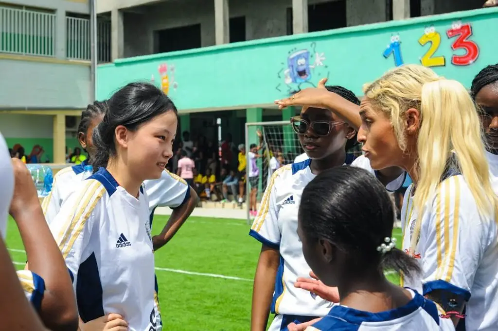 Coach Bex Price interacting with American School of Douala students during the DISSAC football competition in Cameroon.
