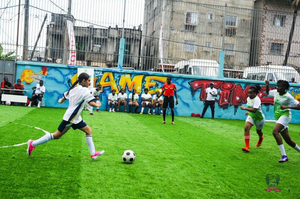 American School of Douala football player advancing with the ball during a DISSAC interschool match