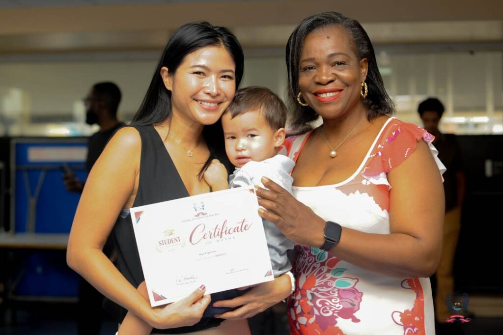 American School of Douala student celebrates an October Student of the Month award alongside members of the school community